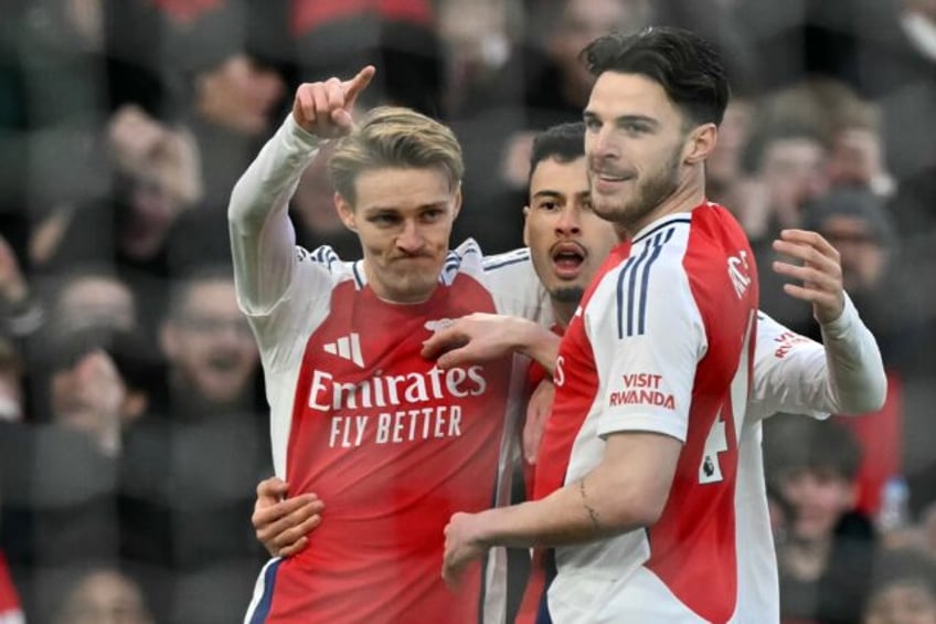 Arsenal's Martin Odegaard (L) celebrates scoring against Manchester City