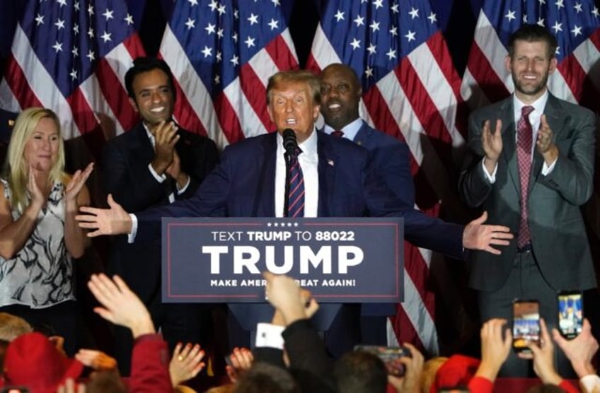 Republican presidential hopeful Donald Trump gestures to his supporters after winning the New Hampshire primary