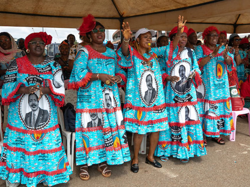 Attendees cheer and dance during the celebration of 42 years of Cameroonian President Paul Biya being in power at the town hall in Yaounde on November 6, 2024. (Photo by ETIENNE NSOM / AFP)