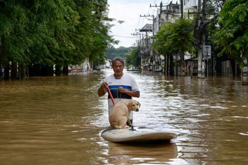 Tourists evacuated hotels through knee-high muddy water in Thailand's city of Chiang Mai