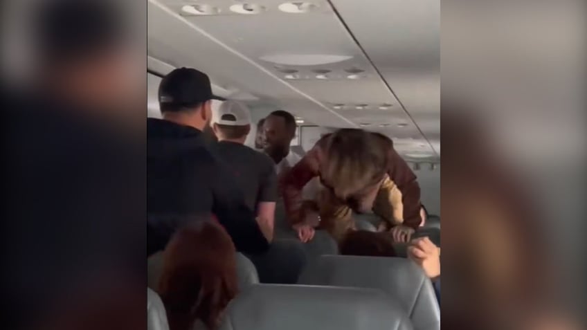 flight descends into chaos when possessed woman begins screaming jumping over seats theres a real devil