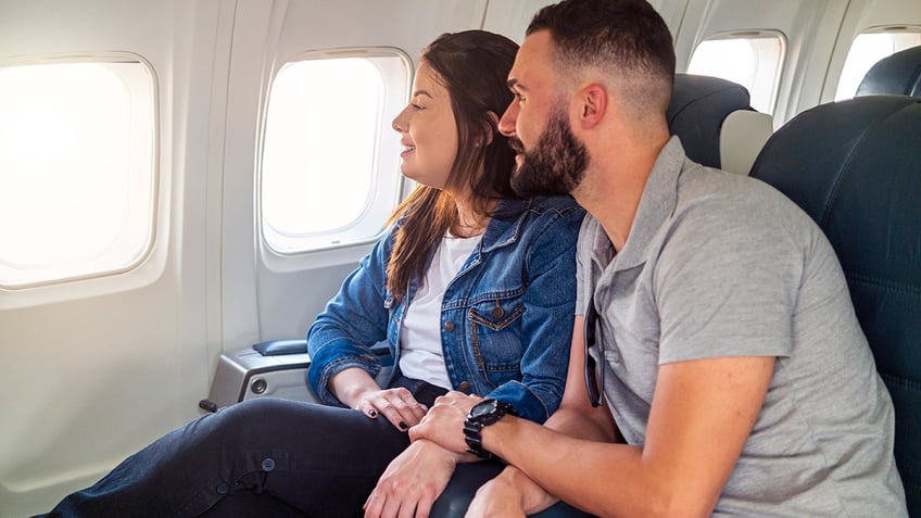 couple sitting together on plane