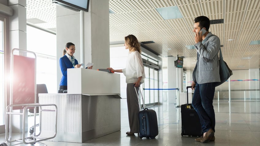 couple in line with gate agent at airport