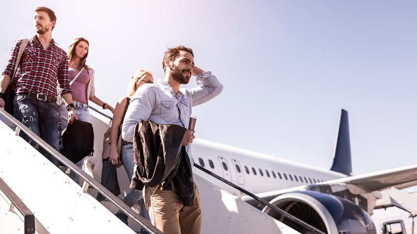 passengers getting off flight