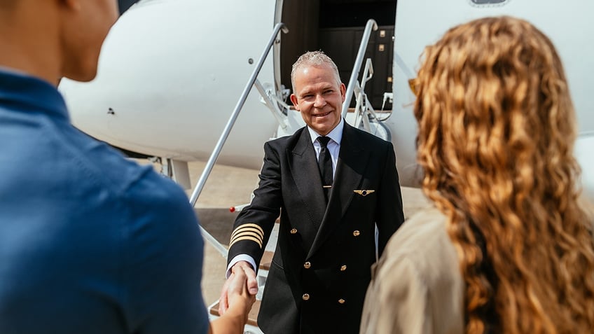 couple thanking pilot after flight