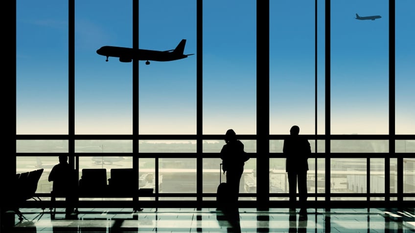 Waiting in the airport terminal watching planes