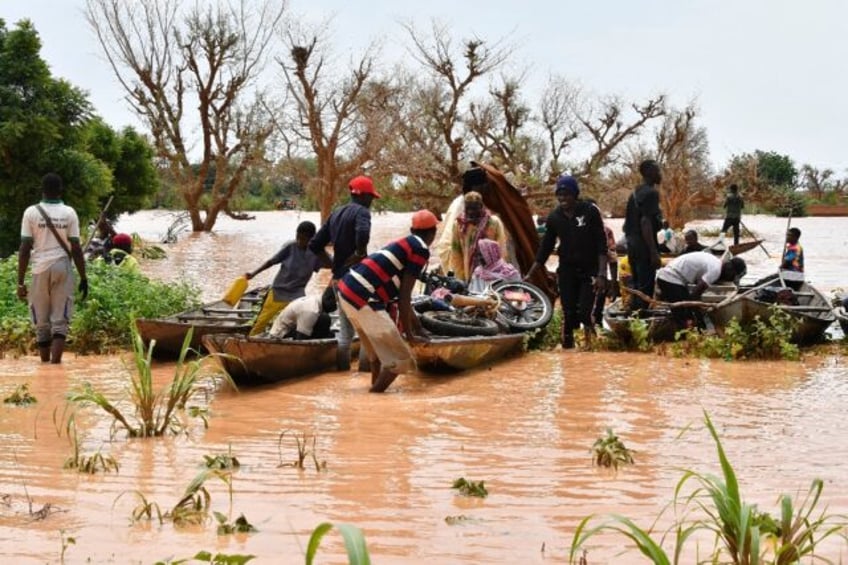 Canoes have replaced other forms of transport after heavy rains in Niger