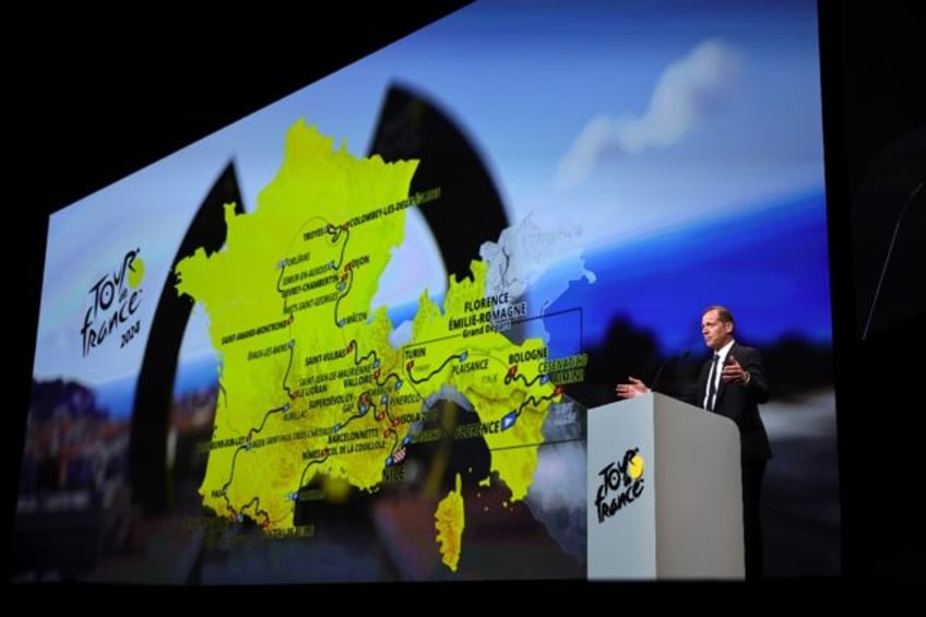 Tour de France Director Christian Prudhomme in front of 2024 route map