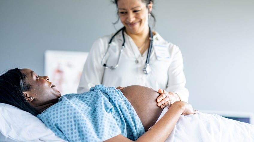 Pregnant woman with doctor