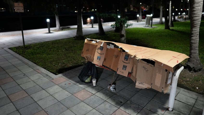 Person sleeping on bench in Miami