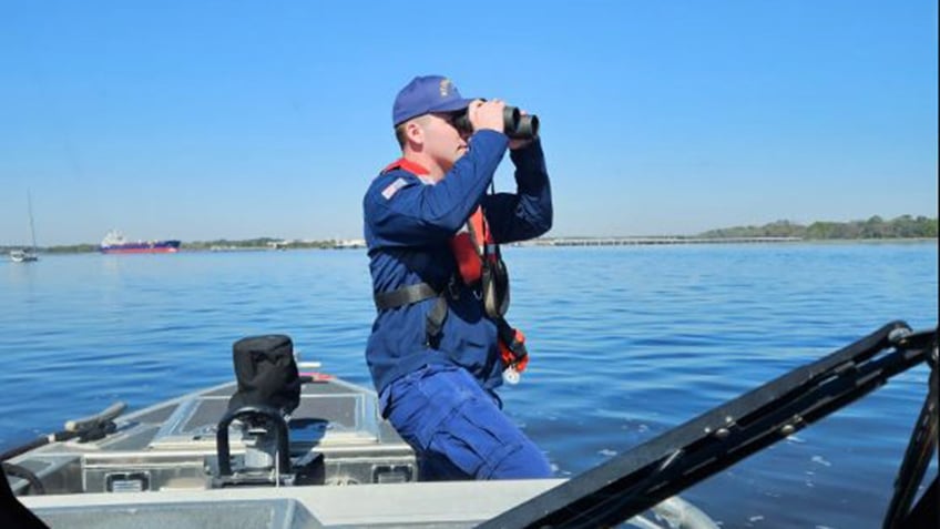 Coast Guard member searching