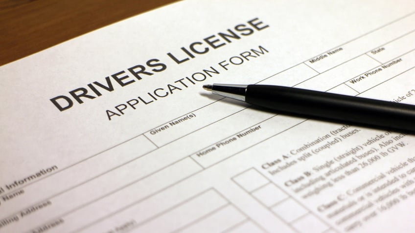 Someone filling out Drivers License Application Form