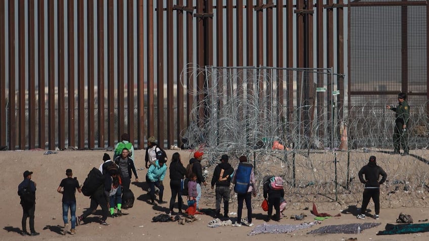 Migrants on the Mexico side of the border