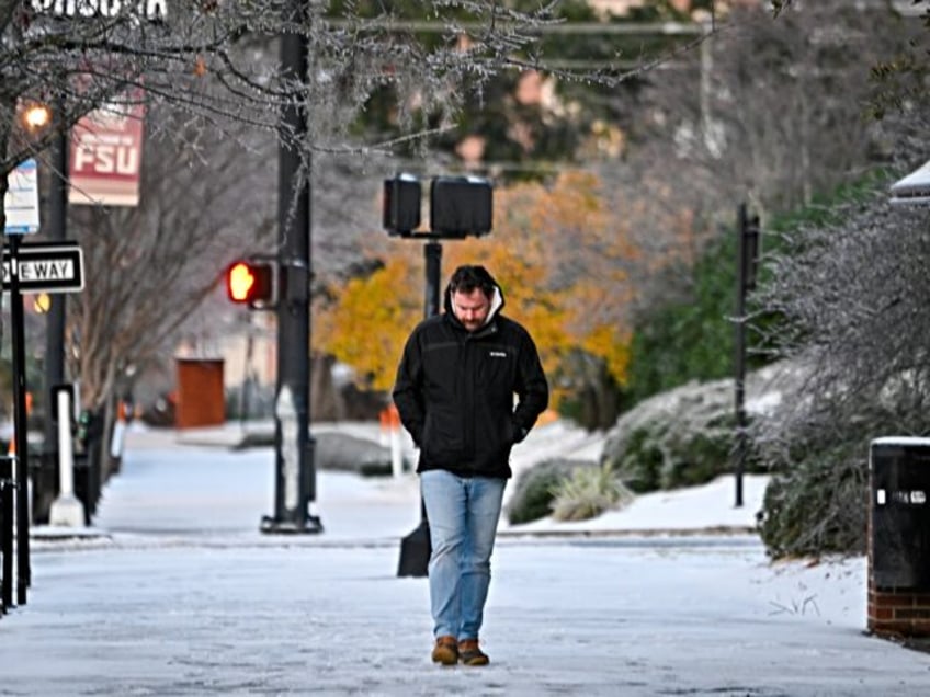 TALLAHASSEE, FLORIDA - JANUARY 22: A person walks on snow after snowfall on January 22, 20