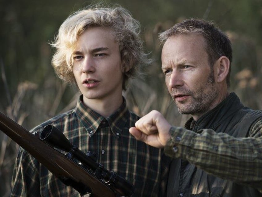 Young man and older man hunting rifle gun