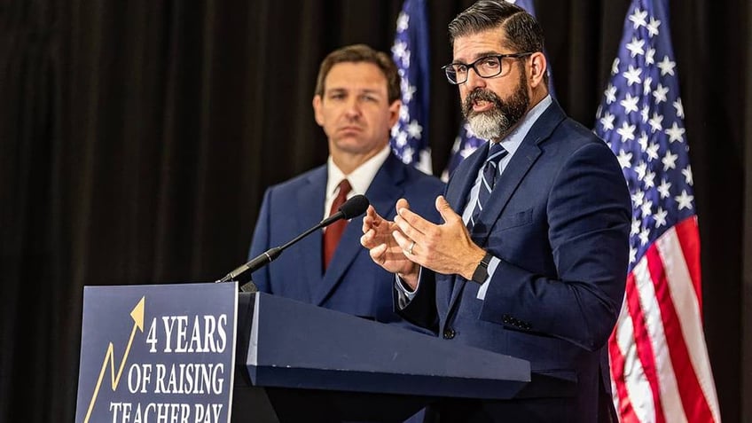 Florida Education Commissioner Manny Diaz speaking with Florida Gov. Ron DeSantis next to him