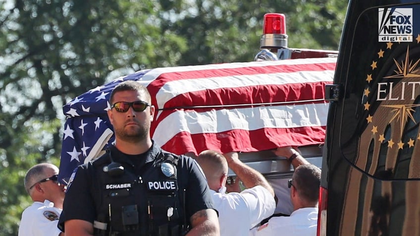 The casket of Corey Comperatore is carried into Cabot United Methodist Church