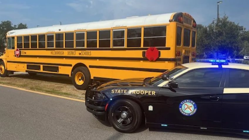 Hillsborough Co. school bus next to police car