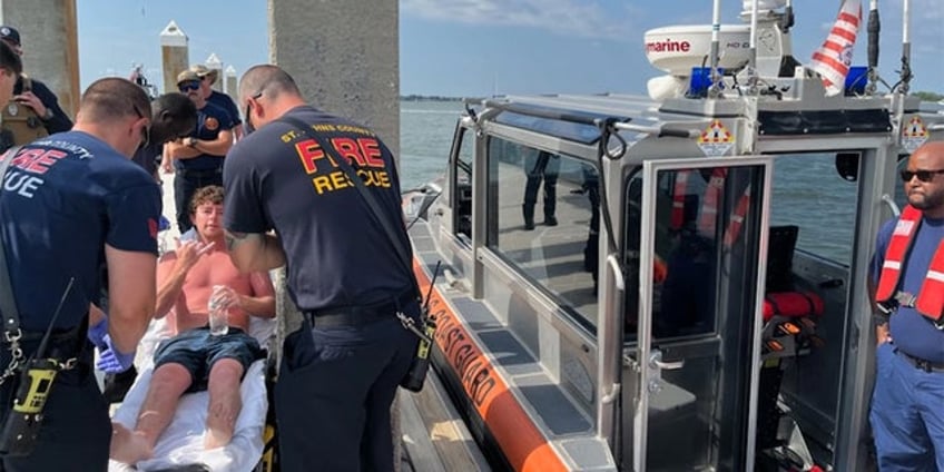 florida man saved at sea by coast guard from partially submerged boat after 24 hour search and rescue effort