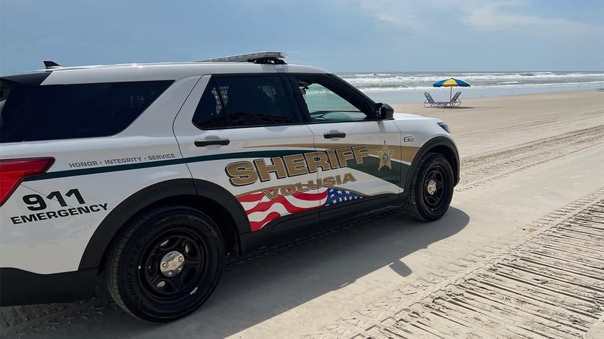 Police cruiser on a beach