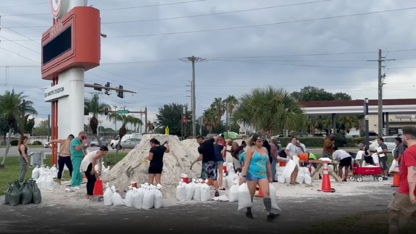 florida residents shovel piles of sand into bags as idalia approaches video