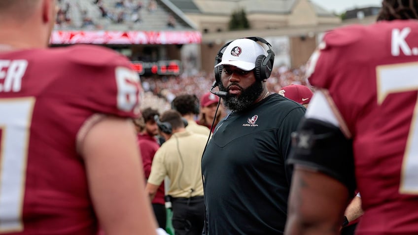 Alex Atkins stands on the sidelines