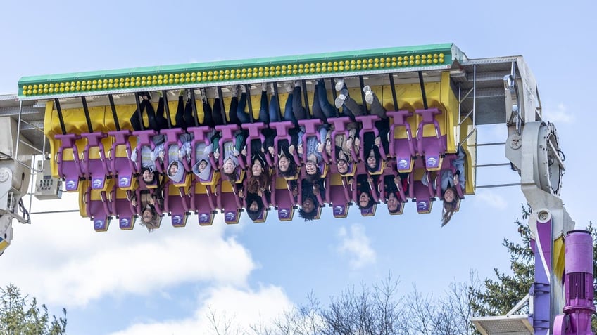 People upside down on an amusement park ride called the Moon Chaser