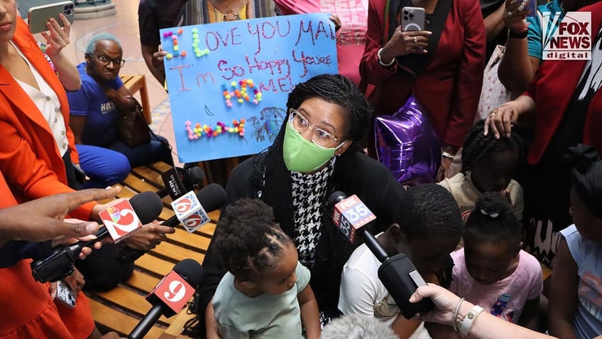 Sharitta Grier speaks to the media at the airport