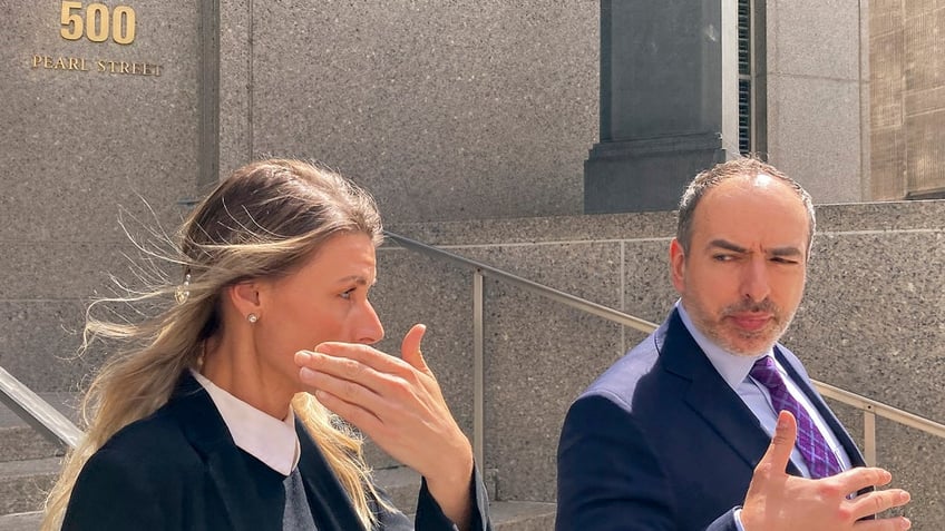 Aimee Harris with her attorney outside a New York courthouse