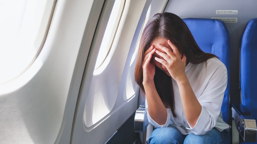 woman with major ear pain on flight