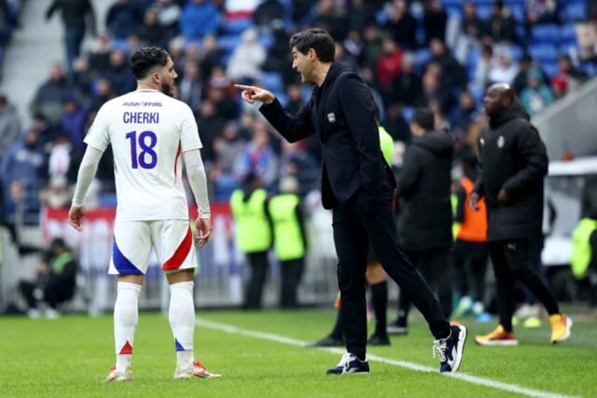 New Lyon coach Paulo Fonseca (R) speaks with Rayan Cherki during the 4-0 win over Reims in