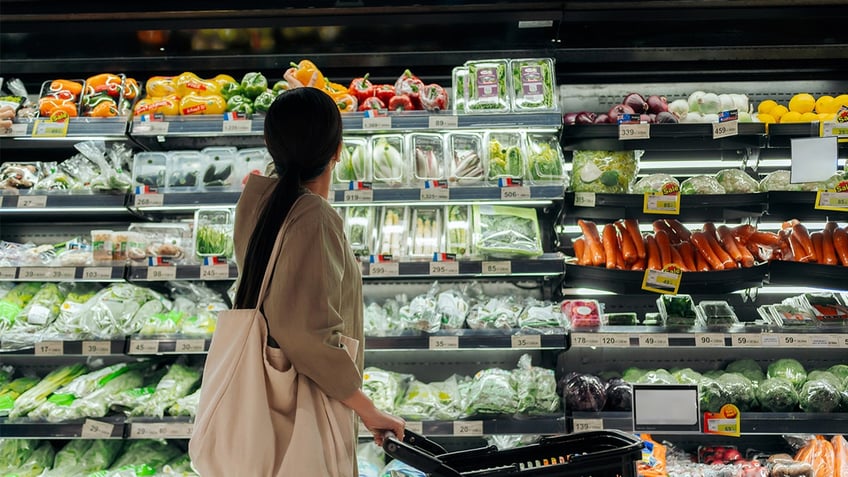 Woman shopping in produce aisle