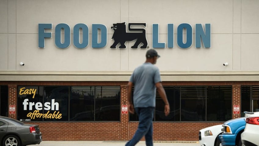 Person walks past Food Lion store