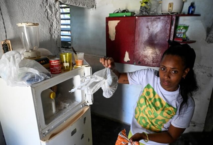 Diana Ruiz and her nearly empty refrigerator, photographed in Havana on March 27, 2024