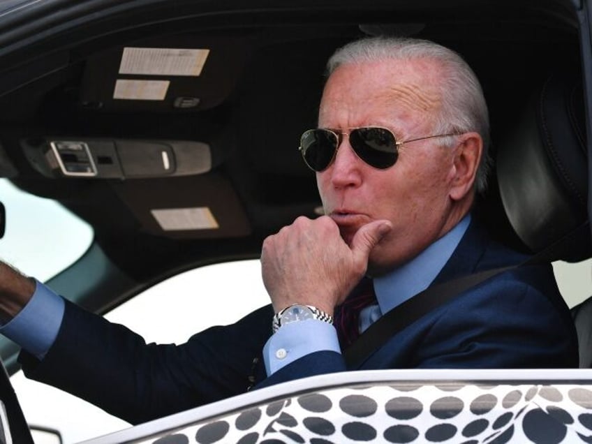 US President Joe Biden drives the new electric Ford F-150 Lightning at the Ford Dearborn Development Center in Dearborn, Michigan on May 18, 2021. (Photo by Nicholas Kamm / AFP) (Photo by NICHOLAS KAMM/AFP via Getty Images)