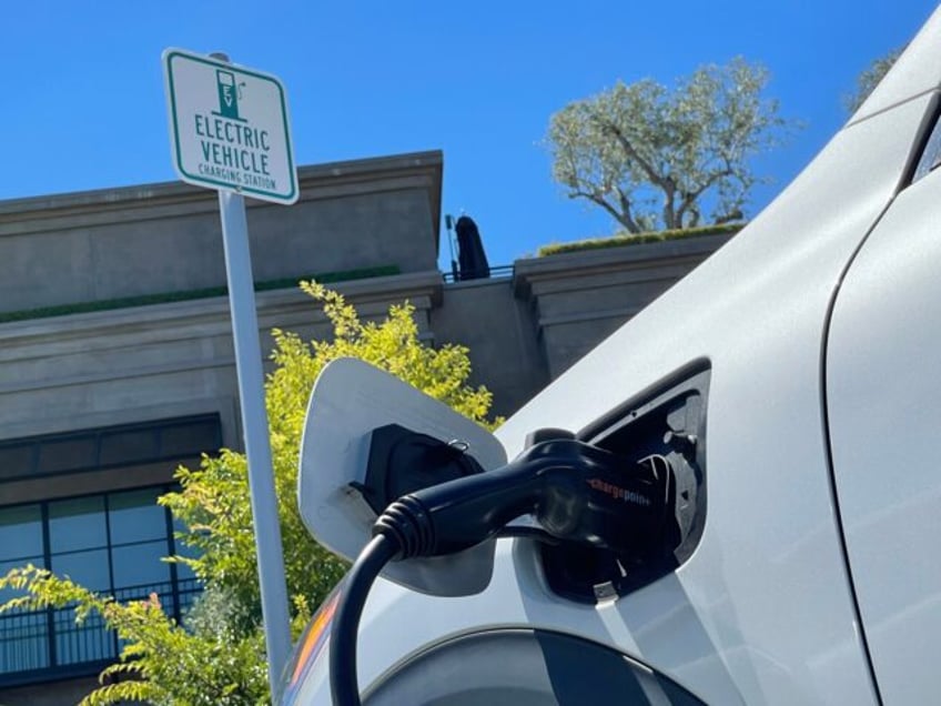 CORTE MADERA, CALIFORNIA - JUNE 27: An electric car charges at a mall parking lot on June