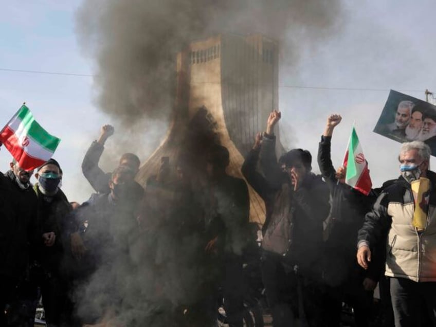 People burn a U.S. flag during a rally at Azadi (Freedom) Square celebrating the 42nd anni