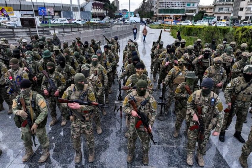 Fighters affiliated with Syria's new administration at a military parade in Damascus