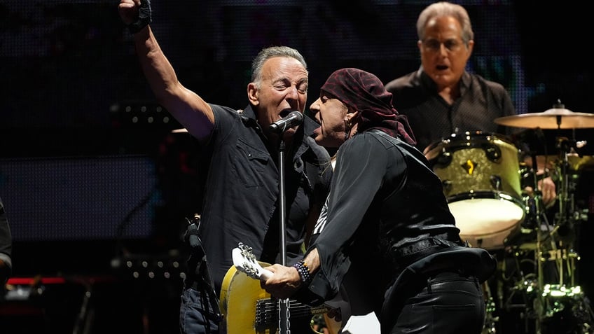 Bruce Springsteen singing with Steven Van Zandt on stage