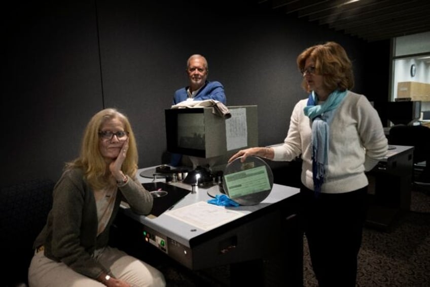 (L-R) Jennifer Taylor-Rossel, Robert Neal Marshall and Patricia Spae look through archive