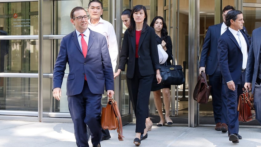 Linda Sun and husband leave court