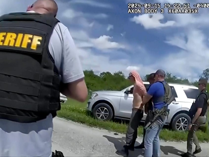 In this image taken from police body camera video and released by the Martin County, Fla., Sheriff’s Office, law enforcement officers arrest Ryan Routh, the man suspected in the apparent assassination attempt of Donald Trump, Sunday, Sept. 15, 2024. (Martin County Sheriff’s Office via AP)