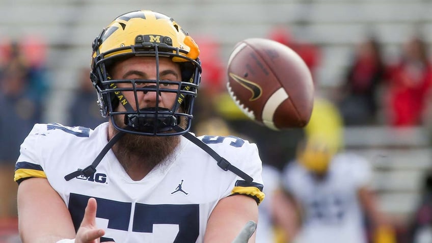 Michigan Wolverines offensive lineman Patrick Kugler looks on before a game