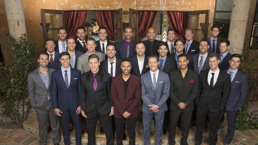 group photo of men in suiting smiling at camera