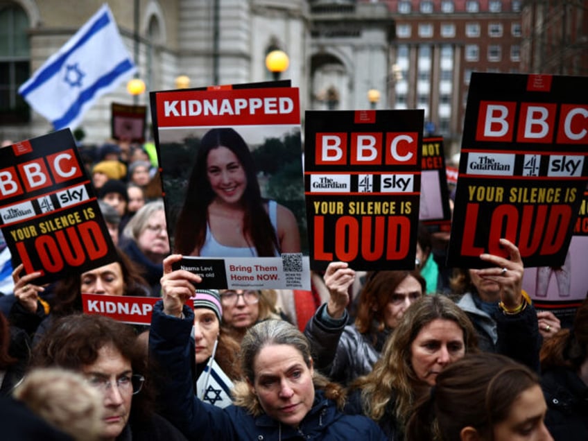 Protesters wearing fake blood make-up and holding placards take part in a demonstration "R