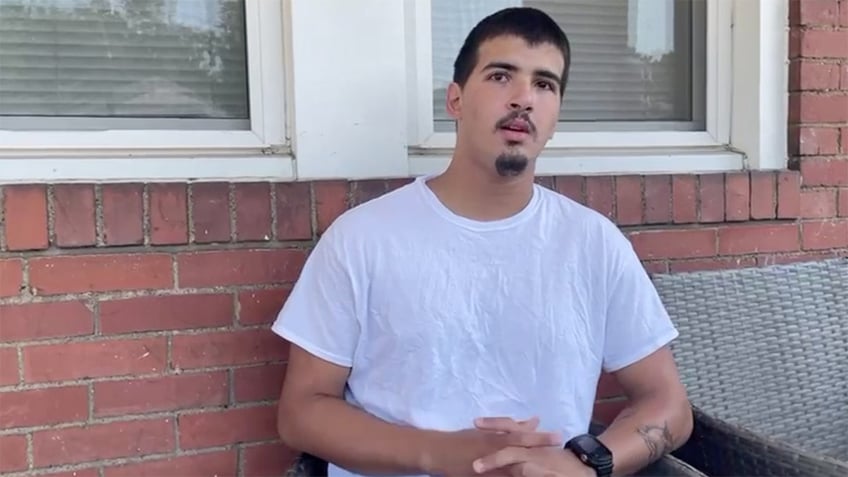 Vincent Taormina wearing a white T-shirt while answering questions on his front porch near Pittsburgh