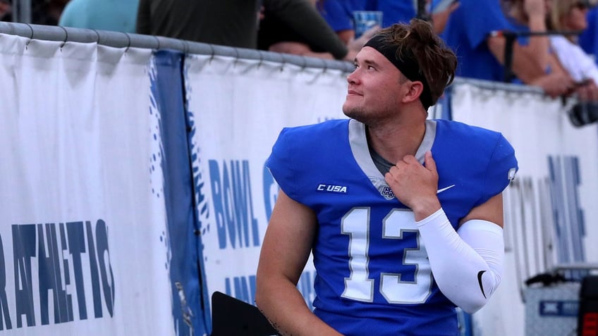 Kyle Ulbrich stands on the football field