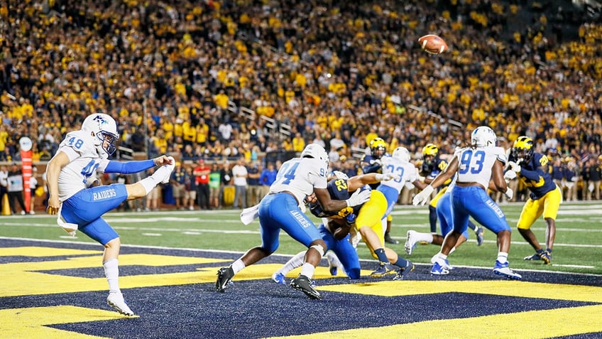 Kyle Ulbrich punts during a game