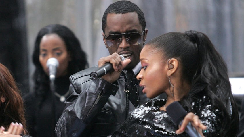 D Woods and Diddy perform on stage