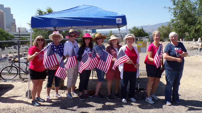 Women posing with American flags